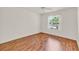 Bright bedroom with a ceiling fan, wood-look floors, and a window at 381 Corbett Dr, The Villages, FL 32162
