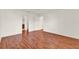 Spacious bedroom with wood-look floors and access to the ensuite bathroom at 381 Corbett Dr, The Villages, FL 32162