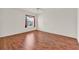 Bright bedroom featuring wood-look floors and a window at 381 Corbett Dr, The Villages, FL 32162
