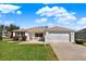 Charming single-story home features a well-manicured lawn and a two-car garage at 381 Corbett Dr, The Villages, FL 32162