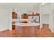 Bright kitchen with stainless steel appliances, wood cabinets, and a center island at 381 Corbett Dr, The Villages, FL 32162