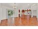 Open-concept living space with wood flooring and a sliding glass door to the patio at 381 Corbett Dr, The Villages, FL 32162
