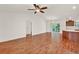 Spacious living room featuring wood floors, ceiling fan, and natural light at 381 Corbett Dr, The Villages, FL 32162