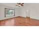 Inviting living room with wood floors and a ceiling fan offering comfort and style at 381 Corbett Dr, The Villages, FL 32162
