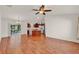 Open-concept living space featuring wood floors that connects seamlessly to the kitchen at 381 Corbett Dr, The Villages, FL 32162