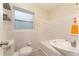 Bright bathroom with white tiling, modern sink and fixtures plus a window for natural light at 3905 Cherry Way, Lakeland, FL 33805