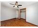 Bedroom featuring a closet, door, ceiling fan and wood flooring at 3905 Cherry Way, Lakeland, FL 33805