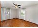 Bedroom with a ceiling fan, two windows and wood flooring at 3905 Cherry Way, Lakeland, FL 33805