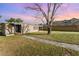 Charming single-story home featuring a well-maintained lawn and mature tree at 3905 Cherry Way, Lakeland, FL 33805