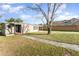 Charming single story home with a well-maintained lawn and mature tree in front at 3905 Cherry Way, Lakeland, FL 33805