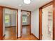 Hallway with wood floors leads to bedrooms and bathroom with wooden trim doors at 3905 Cherry Way, Lakeland, FL 33805