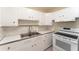 Well-lit kitchen featuring white appliances, bright cabinetry, and ample counter space at 3905 Cherry Way, Lakeland, FL 33805