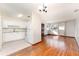 Cozy living room with refinished hardwood floors, ample natural light, and open kitchen at 3905 Cherry Way, Lakeland, FL 33805