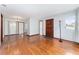 Spacious living room with beautiful hardwood floors, natural light, and neutral paint at 3905 Cherry Way, Lakeland, FL 33805