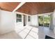 Sun room featuring sliding glass doors, door and wood plank ceiling at 3905 Cherry Way, Lakeland, FL 33805