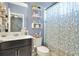 Well-lit bathroom featuring a vanity with sink, toilet, and shower with modern fixtures and decor at 4107 Briar Gate Ln, Winter Garden, FL 34787