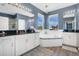 Bright bathroom features a garden tub with tile accents, dual sinks with granite countertops, and modern lighting at 4107 Briar Gate Ln, Winter Garden, FL 34787