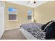 Bright bedroom with patterned bedding, two large windows, and a neutral color scheme, creating a relaxing atmosphere at 4107 Briar Gate Ln, Winter Garden, FL 34787