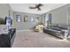 Cozy living room with gray walls, a modern ceiling fan, and a large leather sofa, perfect for movie nights at 4107 Briar Gate Ln, Winter Garden, FL 34787