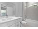 Bright bathroom features white vanity, shower over bath, and tiled walls at 4198 Sw 128Th Pl, Ocala, FL 34473