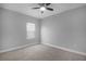 Neutral bedroom with plush carpet, ceiling fan and light filled window at 4198 Sw 128Th Pl, Ocala, FL 34473