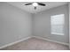 Neutral bedroom with plush carpet, ceiling fan and light filled window at 4198 Sw 128Th Pl, Ocala, FL 34473