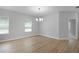 Dining room with wood floors, contemporary chandelier and view to the front yard at 4198 Sw 128Th Pl, Ocala, FL 34473