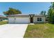 Charming single-story home with a two-car garage, beautiful landscaping, and a well-maintained lawn at 4198 Sw 128Th Pl, Ocala, FL 34473
