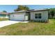 Stylish single-Gathering home featuring a well-manicured lawn, double garage, and charming curb appeal at 4198 Sw 128Th Pl, Ocala, FL 34473