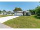 Inviting single-Gathering home featuring a lush green lawn, double garage, and a serene neighborhood setting at 4198 Sw 128Th Pl, Ocala, FL 34473