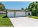 Inviting single-story home with double garage doors, a well-kept lawn, and a classic design at 4198 Sw 128Th Pl, Ocala, FL 34473