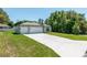 Attractive single-story home with a generous driveway leading to a two-car garage, surrounded by green lawns at 4198 Sw 128Th Pl, Ocala, FL 34473