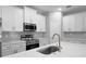 Modern kitchen with stainless appliances, shaker cabinets and a large island at 4198 Sw 128Th Pl, Ocala, FL 34473