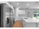 Modern kitchen with stainless appliances and shaker cabinets with a large island at 4198 Sw 128Th Pl, Ocala, FL 34473