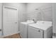 Bright laundry room with modern washer and dryer and built-in shelving at 4198 Sw 128Th Pl, Ocala, FL 34473