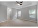 Spacious main bedroom featuring a tray ceiling, neutral carpet, and two large windows at 4198 Sw 128Th Pl, Ocala, FL 34473