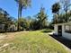 Backyard features include a shed, trees, and lush green grass at 472 Rosalia Dr, Sanford, FL 32771