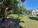 Large backyard with lush grass, trees, and privacy fence at 472 Rosalia Dr, Sanford, FL 32771