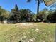 Wide backyard showing a shed, mature trees, and greenery at 472 Rosalia Dr, Sanford, FL 32771