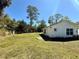 Spacious backyard with lush greenery, offering a serene outdoor living space and natural light at 472 Rosalia Dr, Sanford, FL 32771
