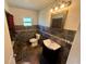 Bathroom featuring a toilet, sink, mirror, vanity lighting, and tiled walls at 472 Rosalia Dr, Sanford, FL 32771