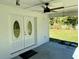 Covered front entrance with elegant double doors, ceiling fan, and green lawn view at 472 Rosalia Dr, Sanford, FL 32771