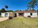 A single story home with an attached carport and a well-manicured lawn at 472 Rosalia Dr, Sanford, FL 32771