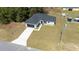 Aerial view showcasing a home with a long driveway and large front lawn at 4914 Sw 147Th Loop, Ocala, FL 34473
