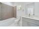 Modern bathroom features stylish tile, a large mirror, and a combined tub and shower at 4914 Sw 147Th Loop, Ocala, FL 34473