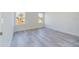 Bright bedroom with light gray flooring, two windows with natural light and white trim at 4914 Sw 147Th Loop, Ocala, FL 34473