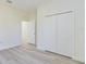 Bedroom features light gray flooring, white trim, and a double door closet at 4914 Sw 147Th Loop, Ocala, FL 34473