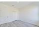 Bedroom features light gray flooring, white trim, and a double door closet at 4914 Sw 147Th Loop, Ocala, FL 34473