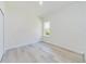 Bright bedroom featuring wood-look floors and a large window at 4914 Sw 147Th Loop, Ocala, FL 34473