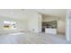 Bright, open living area featuring modern floors and an adjacent kitchen space at 4914 Sw 147Th Loop, Ocala, FL 34473